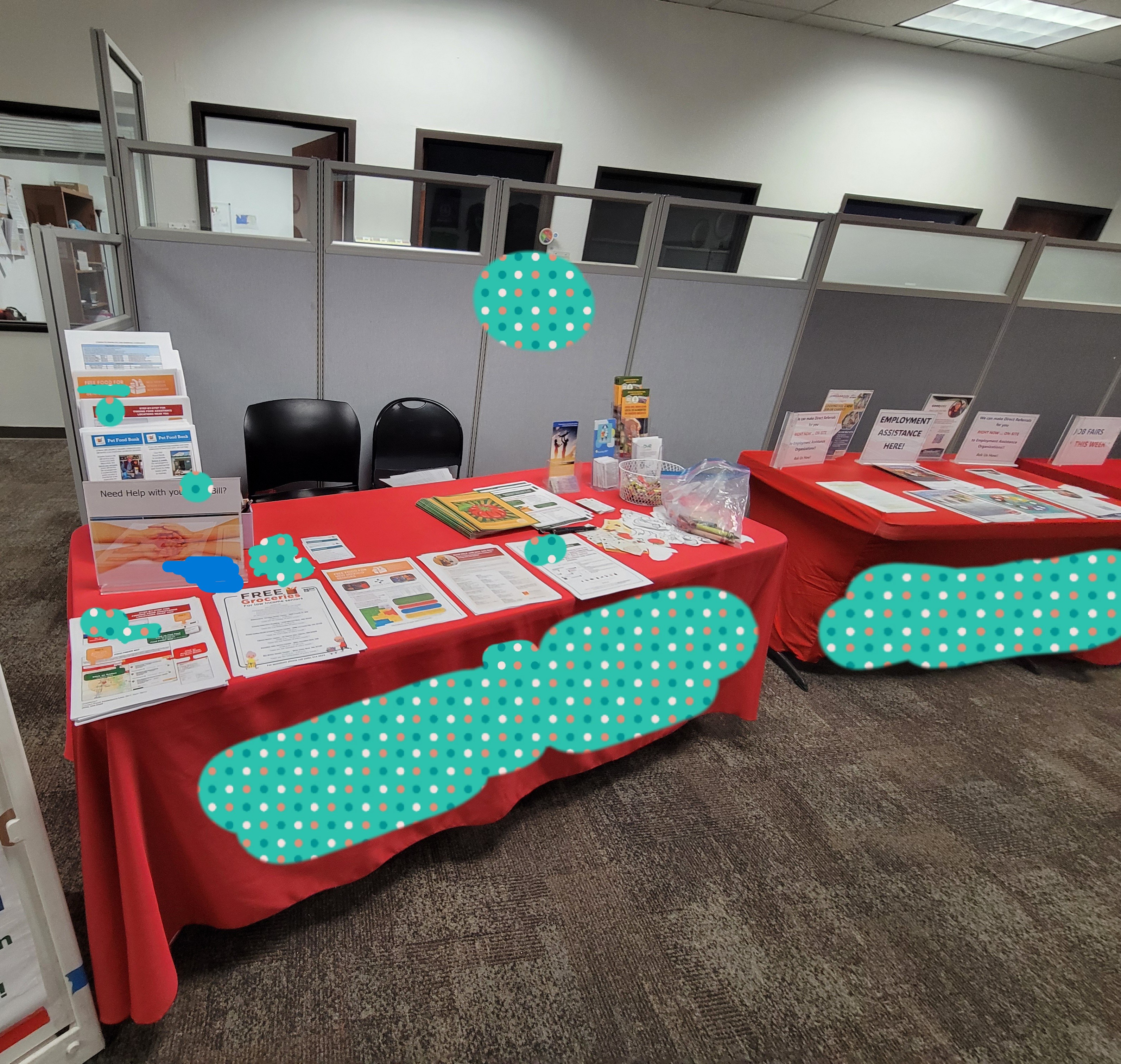 Community resources tables with signs and flyers on different programs.
